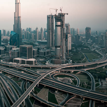 A skyline of a large modern city with a network of highways